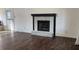 Cozy living room showcasing a stone fireplace and rich hardwood flooring at 3065 Ashly Pines Dr, Snellville, GA 30078