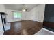 Open-concept living room with hardwood floors, fireplace, fan, and great natural light at 3065 Ashly Pines Dr, Snellville, GA 30078
