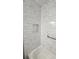 Shower stall featuring marble style tile, grab bar and a built-in soap niche at 3065 Ashly Pines Dr, Snellville, GA 30078