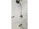 Close up of shower featuring marble style tile, a handheld shower head, and a tub faucet at 3065 Ashly Pines Dr, Snellville, GA 30078