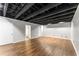 Unfinished basement with wood flooring and painted ceiling at 1290 Fernwood Ne Cir, Brookhaven, GA 30319