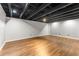 Unfinished basement with wood flooring and an exposed ceiling at 1290 Fernwood Ne Cir, Brookhaven, GA 30319