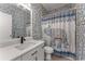 Charming bathroom with stylish wallpaper, modern vanity, and an elephant-themed shower curtain at 1290 Fernwood Ne Cir, Brookhaven, GA 30319