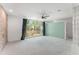 Large bedroom with a ceiling fan, carpet floors, and a large window with green view at 1290 Fernwood Ne Cir, Brookhaven, GA 30319