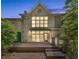 Backyard view showcasing the home's deck with lush green landscaping and great natural light at 1290 Fernwood Ne Cir, Brookhaven, GA 30319