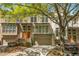 Charming townhome with a brick facade, attached garage, and well-manicured landscaping at 1290 Fernwood Ne Cir, Brookhaven, GA 30319
