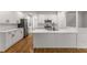 Modern kitchen with stainless steel appliances, white cabinets, hardwood floors and a large island at 1290 Fernwood Ne Cir, Brookhaven, GA 30319