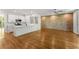 Open concept living area with hardwood floors, brick wall, and kitchen island at 1290 Fernwood Ne Cir, Brookhaven, GA 30319
