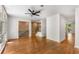 Open-concept living room featuring hardwood floors, brick accent walls, and large windows at 1290 Fernwood Ne Cir, Brookhaven, GA 30319