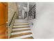Beautiful staircase with wooden treads, white risers, and a sleek black handrail at 1290 Fernwood Ne Cir, Brookhaven, GA 30319