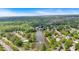 Aerial view showcases the community's lush greenery, a pond, and the tranquil surroundings at 3463 Chastain Glen Ne Ln, Marietta, GA 30066