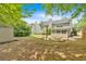 Spacious backyard featuring a fire pit, shed, and lush greenery, perfect for outdoor gatherings at 3463 Chastain Glen Ne Ln, Marietta, GA 30066