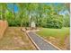 Relax in this backyard with a fire pit and seating under mature trees at 3463 Chastain Glen Ne Ln, Marietta, GA 30066