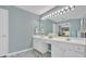 A spacious bathroom features double vanity, an extra long mirror and marble floors at 3463 Chastain Glen Ne Ln, Marietta, GA 30066