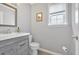 Half bathroom with a modern vanity, light gray walls, and new flooring at 3463 Chastain Glen Ne Ln, Marietta, GA 30066