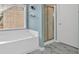 A tiled shower stall and bathtub in a spacious bathroom with marble floors at 3463 Chastain Glen Ne Ln, Marietta, GA 30066