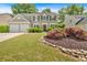 Beautiful home with manicured lawn, stone-lined flower beds, and colorful shrubs at 3463 Chastain Glen Ne Ln, Marietta, GA 30066