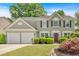 Charming two-story home featuring a manicured lawn, a two-car garage, and beautiful landscaping at 3463 Chastain Glen Ne Ln, Marietta, GA 30066