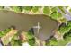Aerial view of a pond with a fountain surrounded by lush greenery, providing a serene community amenity at 3463 Chastain Glen Ne Ln, Marietta, GA 30066
