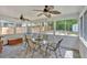 Enclosed sunroom features stone flooring, multiple windows and ceiling fans at 3463 Chastain Glen Ne Ln, Marietta, GA 30066