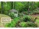 Scenic backyard view featuring a creek, gazebo, and lush landscaping; no flood insurance required at 4094 Norton Se Pl, Smyrna, GA 30082
