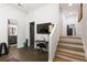 Versatile finished basement area with media space, wood stairs, and access to additional rooms at 4094 Norton Se Pl, Smyrna, GA 30082