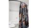 White tiled shower and tub with decorative floral shower curtain at 4094 Norton Se Pl, Smyrna, GA 30082