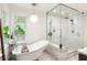 Bright bathroom featuring a soaking tub and large glass enclosed shower with dual shower heads at 4094 Norton Se Pl, Smyrna, GA 30082