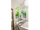 Close up of the bright bathroom featuring a soaking tub and view of the wooded landscape at 4094 Norton Se Pl, Smyrna, GA 30082