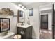 Charming bathroom featuring a vanity with gray cabinets, framed mirror, and decorative accents at 4094 Norton Se Pl, Smyrna, GA 30082