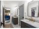 Bright bathroom featuring double vanity with marble countertops, gray cabinets, and a view into a bedroom at 4094 Norton Se Pl, Smyrna, GA 30082