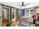 Bedroom featuring a ceiling fan, hardwood floors, and access to a bathroom at 4094 Norton Se Pl, Smyrna, GA 30082