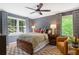 Cozy bedroom featuring a ceiling fan, two windows, and hardwood floors at 4094 Norton Se Pl, Smyrna, GA 30082