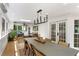 Sunroom dining area featuring a modern light fixture, white wainscoting, and sliding doors to the outdoors at 4094 Norton Se Pl, Smyrna, GA 30082