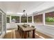 Bright dining room with a large table, modern chandelier, and serene views of the backyard at 4094 Norton Se Pl, Smyrna, GA 30082
