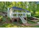 Inviting two-story home featuring a double porch, brick accents, and lush landscaping at 4094 Norton Se Pl, Smyrna, GA 30082