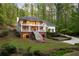 Inviting two-story home with a double balcony, grand staircase, and mature landscaping at 4094 Norton Se Pl, Smyrna, GA 30082