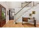 Bright foyer featuring a staircase, hardwood floors, and access to the living room and dining room at 4094 Norton Se Pl, Smyrna, GA 30082