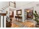 Inviting foyer with a staircase, bench seating, and a view into the adjacent office and kitchen at 4094 Norton Se Pl, Smyrna, GA 30082