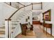 Spacious foyer with a staircase, hardwood floors, and decor, offering a glimpse into the kitchen at 4094 Norton Se Pl, Smyrna, GA 30082