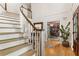 Grand foyer with a curved staircase, hardwood floors, and views into the adjacent office at 4094 Norton Se Pl, Smyrna, GA 30082