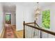 Bright hallway with hardwood floors, white walls, and a view of the living room at 4094 Norton Se Pl, Smyrna, GA 30082