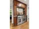 Kitchen with stainless steel stove, hood, custom wood cabinets, and stone backsplash at 4094 Norton Se Pl, Smyrna, GA 30082