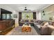 Comfortable living room featuring a large sectional sofa, custom woodwork and a decorative area rug at 4094 Norton Se Pl, Smyrna, GA 30082
