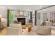 Comfortable living room with a fireplace, ample seating, and a view to the dining area through French doors at 4094 Norton Se Pl, Smyrna, GA 30082