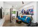 Cozy living room featuring a comfortable blue couch, colorful artwork, and access to workout and laundry areas at 4094 Norton Se Pl, Smyrna, GA 30082