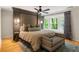 Bedroom featuring a decorative upholstered wall, hardwood floors, and a bay window with backyard views at 4094 Norton Se Pl, Smyrna, GA 30082