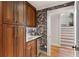 Convenient pantry with custom cabinets, marble countertops, and stylish floral wallpaper at 4094 Norton Se Pl, Smyrna, GA 30082