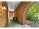 Covered brick patio area with unique archway, creating a welcoming outdoor space at 4094 Norton Se Pl, Smyrna, GA 30082