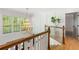 Bright staircase with white wainscoting, wood railing, and a modern gold chandelier at 4094 Norton Se Pl, Smyrna, GA 30082